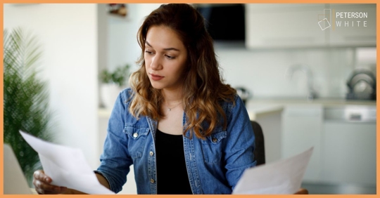 Woman looking over paperwork for her divorce consultation